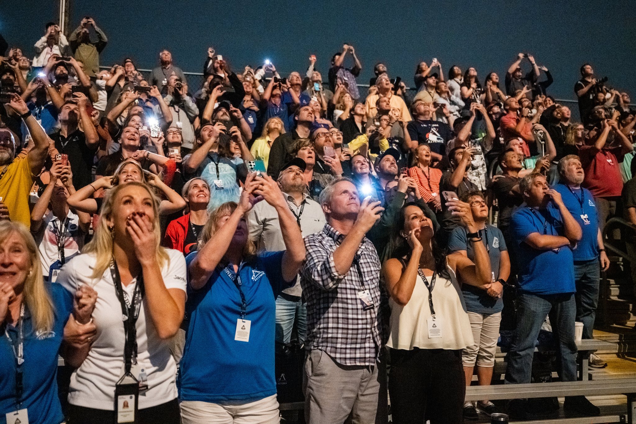 Guests at the Banana Creek viewing site watch the launch of NASA’s Space Launch System rocket carrying the Orion spacecraft.