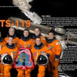 STS-119 crew poster showing the astronauts in orange flight suits, descriptive text about the mission, and the International Space Station