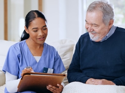 A nurse talks to a senior patient.