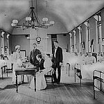 Dr. Joseph Goldberger seated at a table in a hospital.