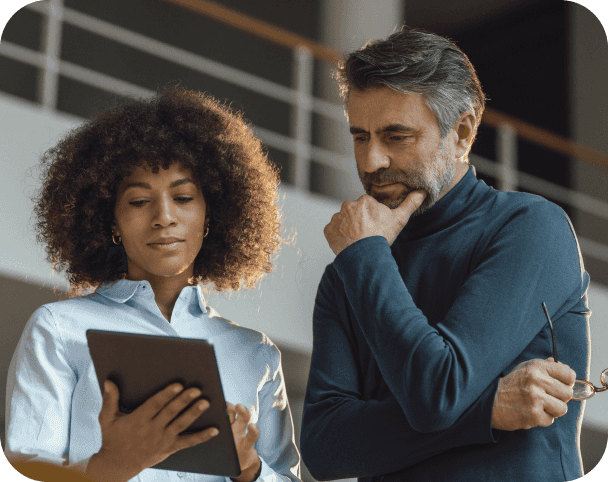 Woman and man standing and staring at smart device