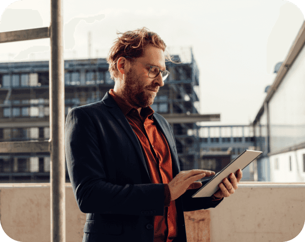 Man standing by window on smart device