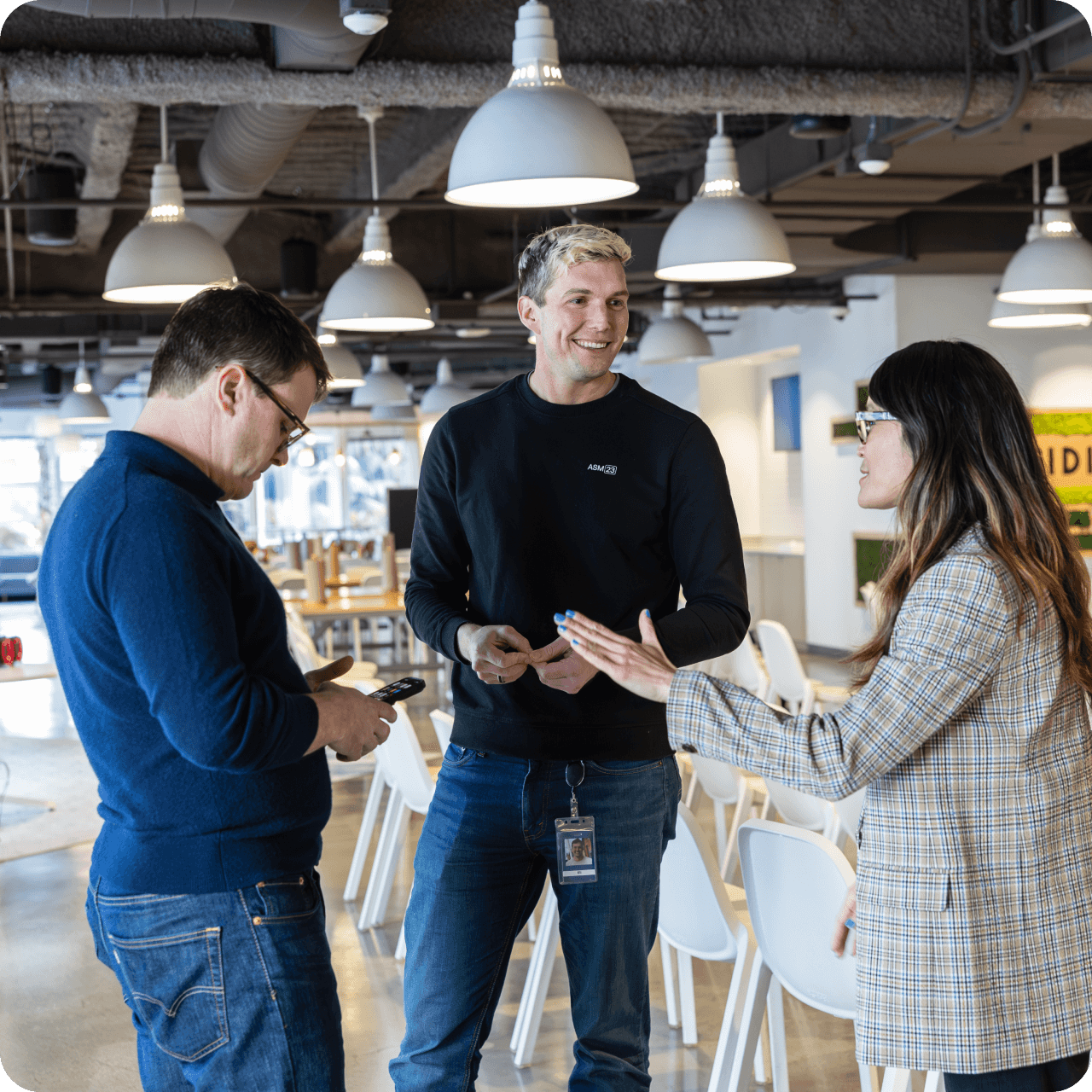 Three colleagues chatting in breakroom