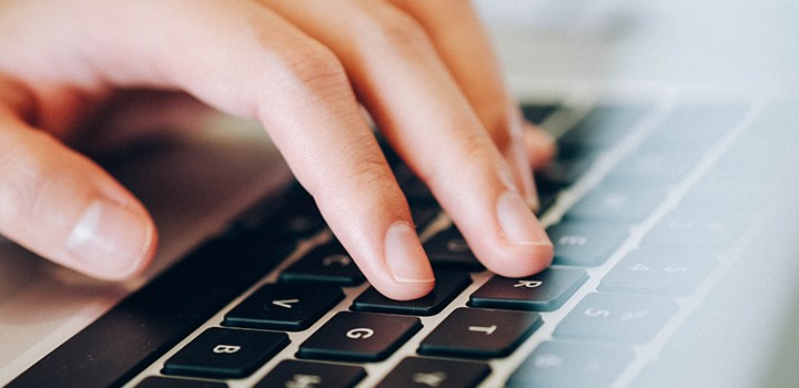 A hand resting on a keyboard.