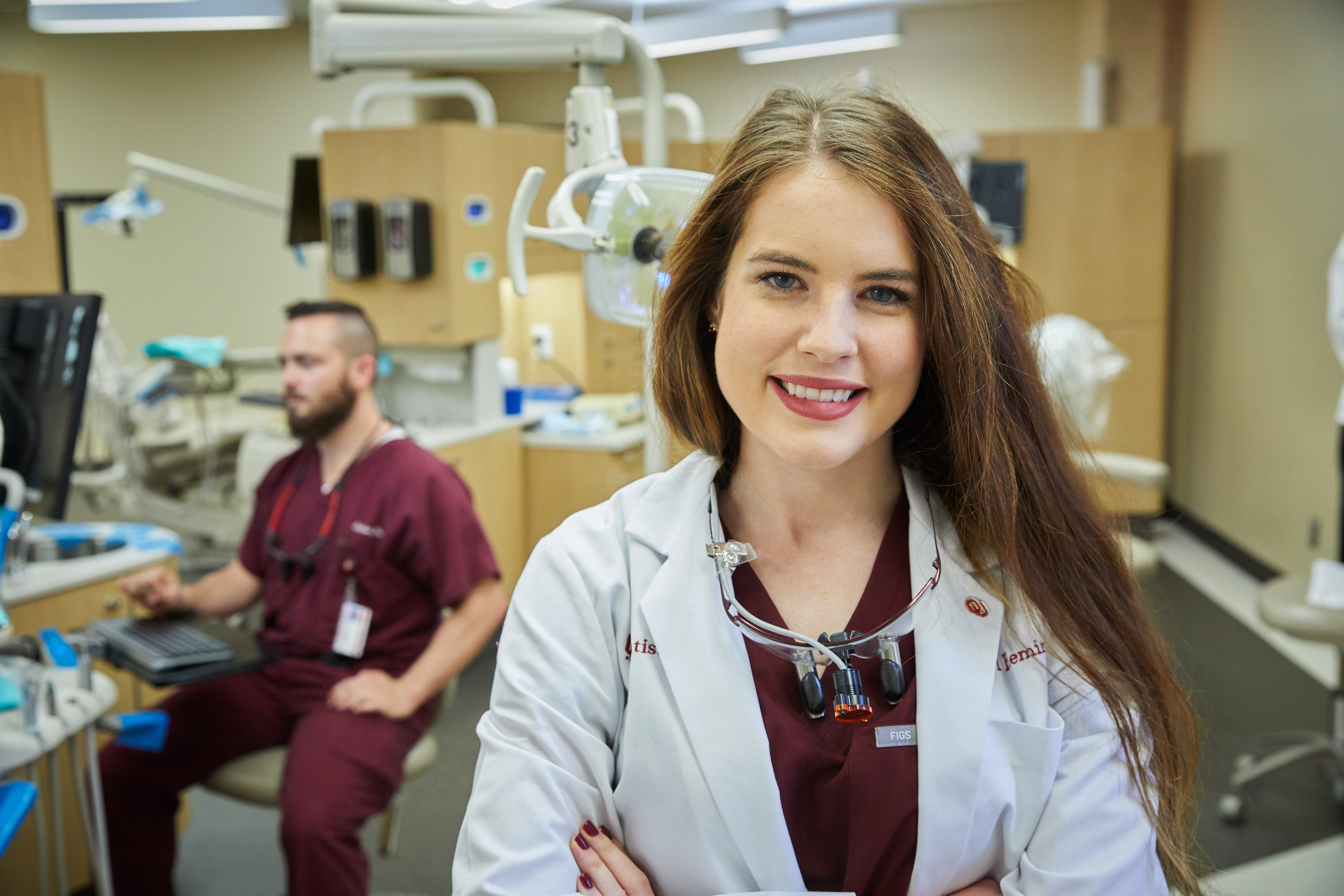 OU dentistry student smiling in their classroom.