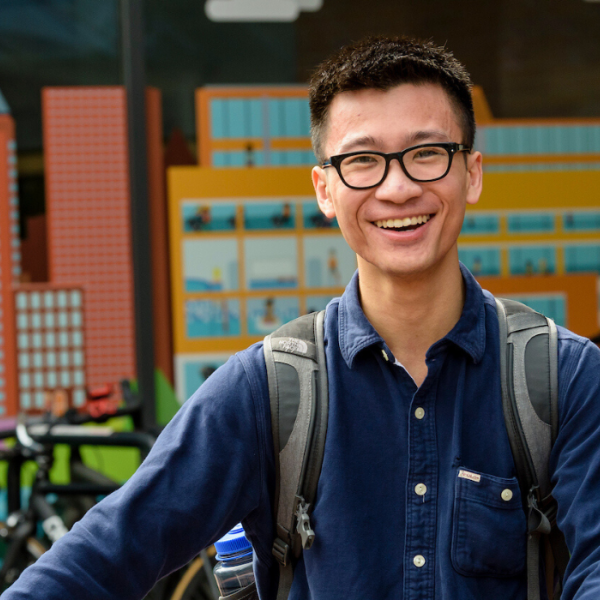 Student with his bike in front of the rec center