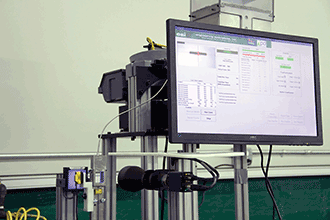 A vision-based inspection machine that takes 250 milliseconds to look at 10 different part characteristics on a small pin used in a seat belt retractor.