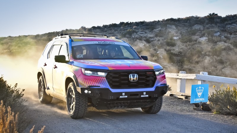 an suv driving on a dirt path