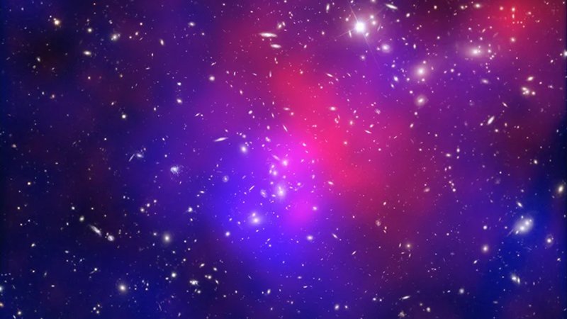 A composite image galaxy cluster collisions known as the Abell 2744 system, known as the Pandora's Cluster. In blue is a map showing the total mass concentration (mostly dark matter) based on data from the Hubble Space Telescope, the Very Large Telescope (VLT), and the Subaru telescope.