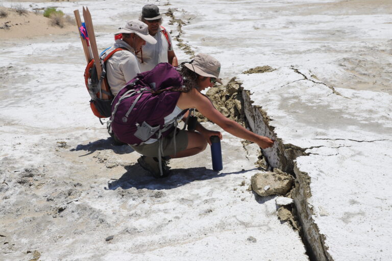 scientists examining a surface rupture in Ridgecrest, CA