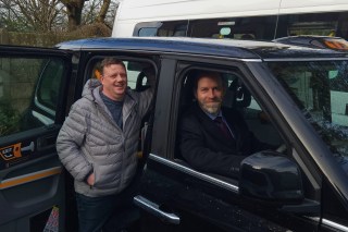 Shaun Delaney, left, founder of Hyde Accessible Transport, with Jonathan Reynolds, the business secretary