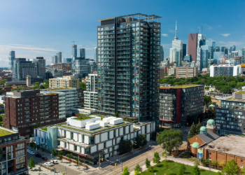 Toronto skyline with blue skies and clusters of buildings in the background.