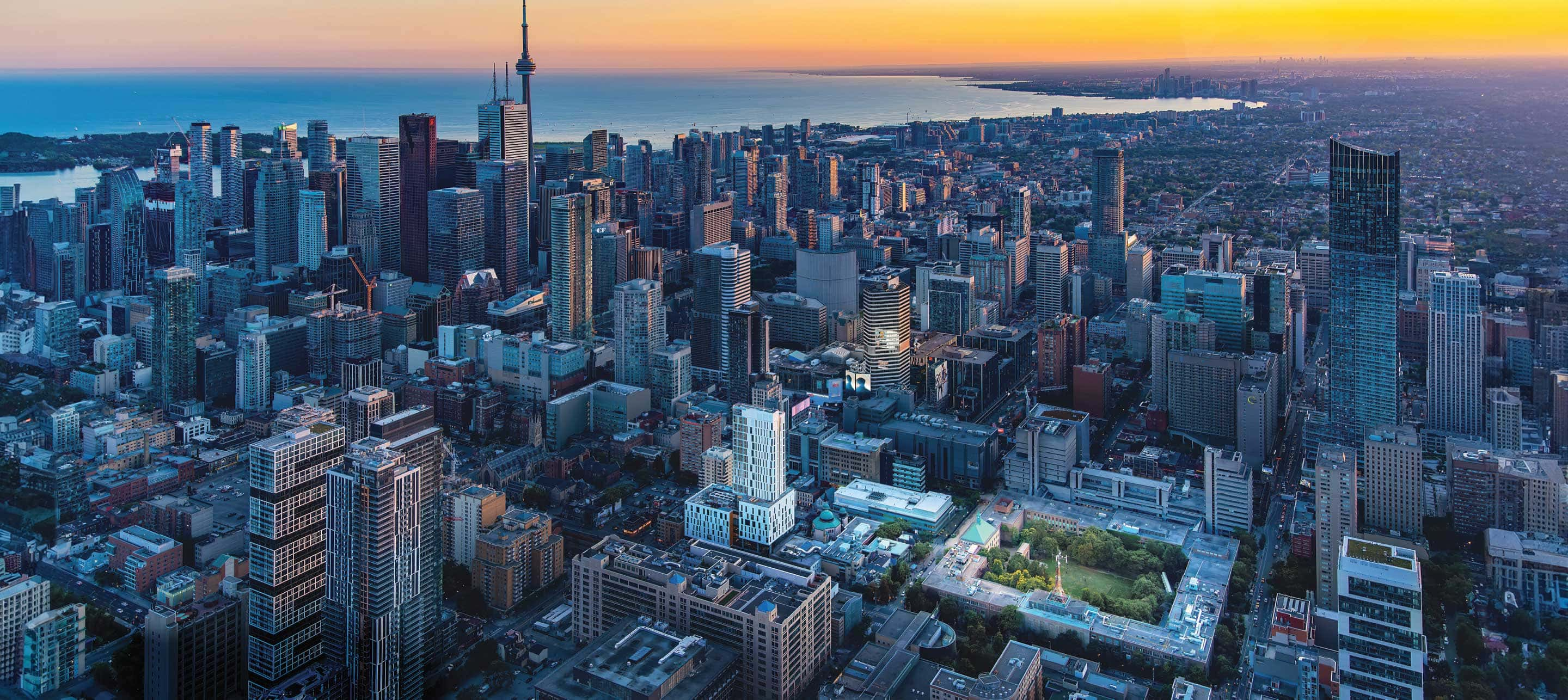 a drone shot of the TMU campus illuminated at dusk in the heart of downtown Toronto