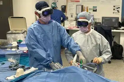 Surgeons wearing Apple Vision Pro headsets during a procedure.