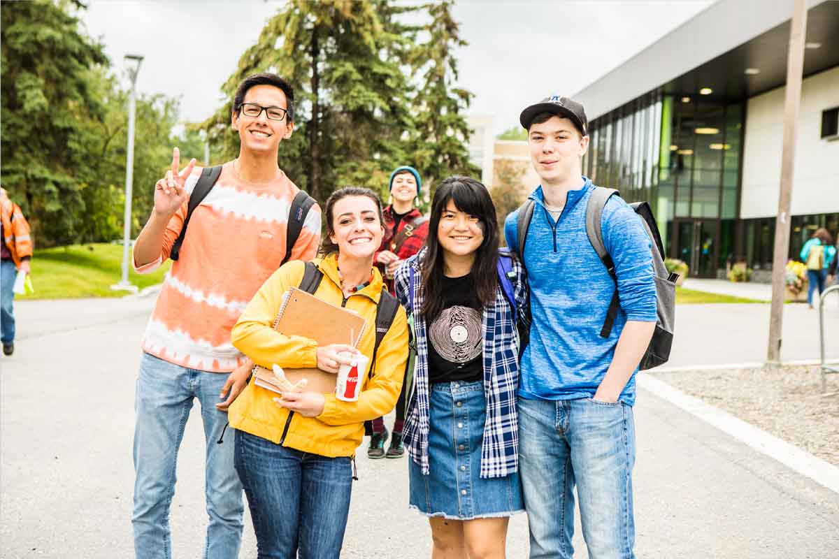 A group of UAF students pose outside the Wood Center