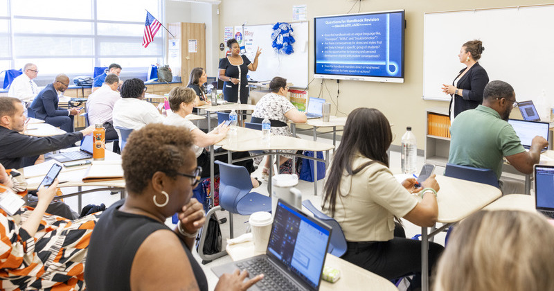 Conference attendees listening to a presenation in a classroom