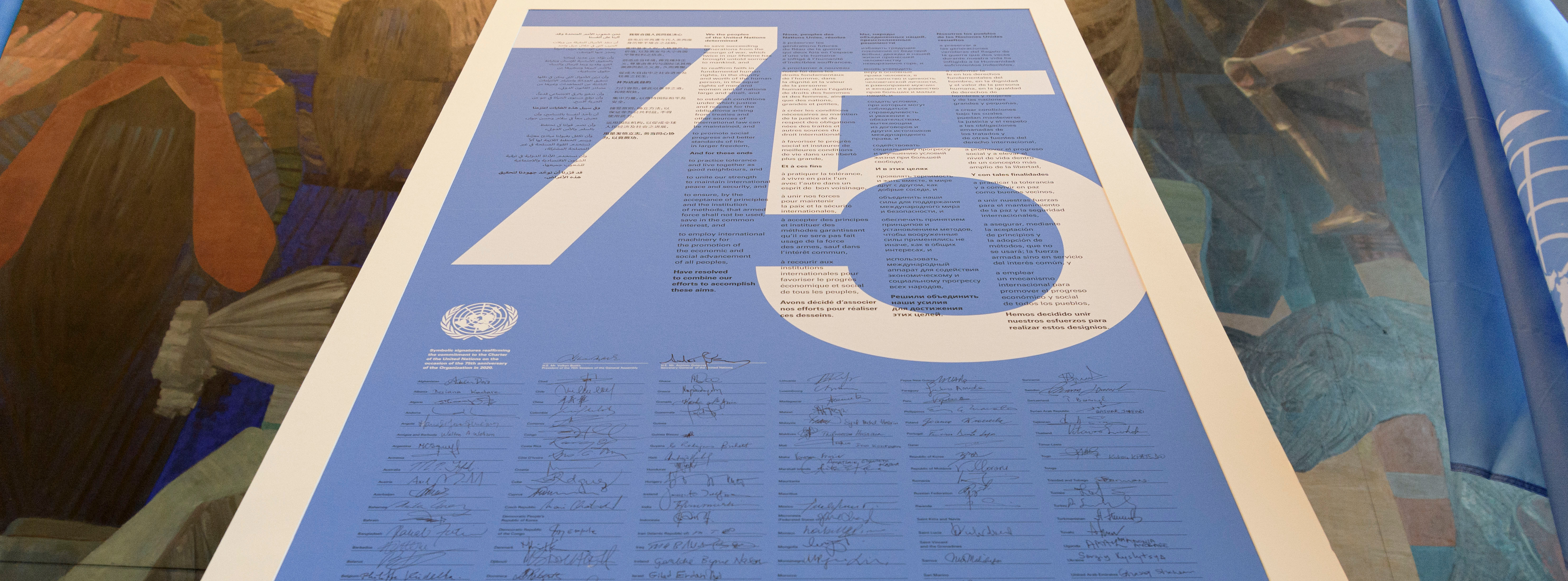 Poster with the numbers 75 and many signatures.&nbsp;