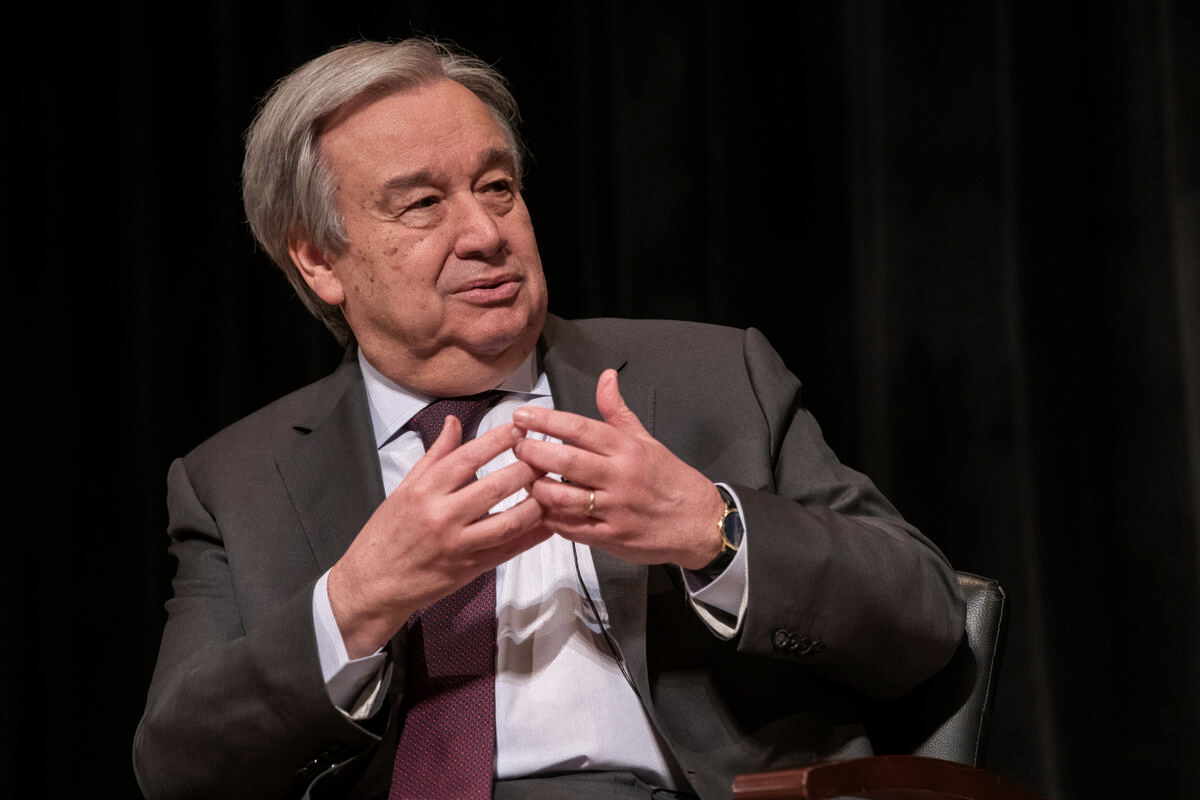 Secretary-General sitting back speaking while moving his hands