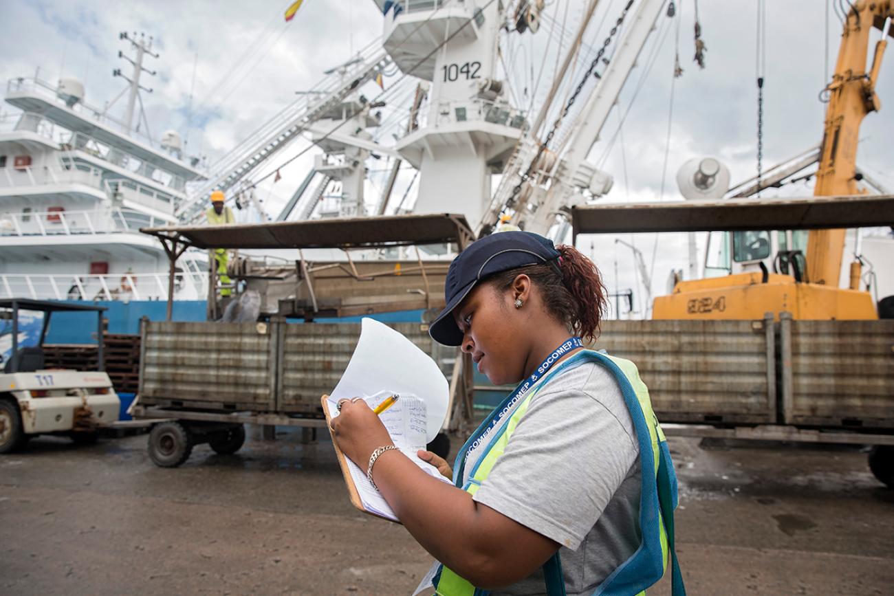 woman with notepad at a dock