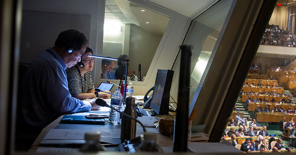 Interpreters at work in a booth at the General Assembly hall.