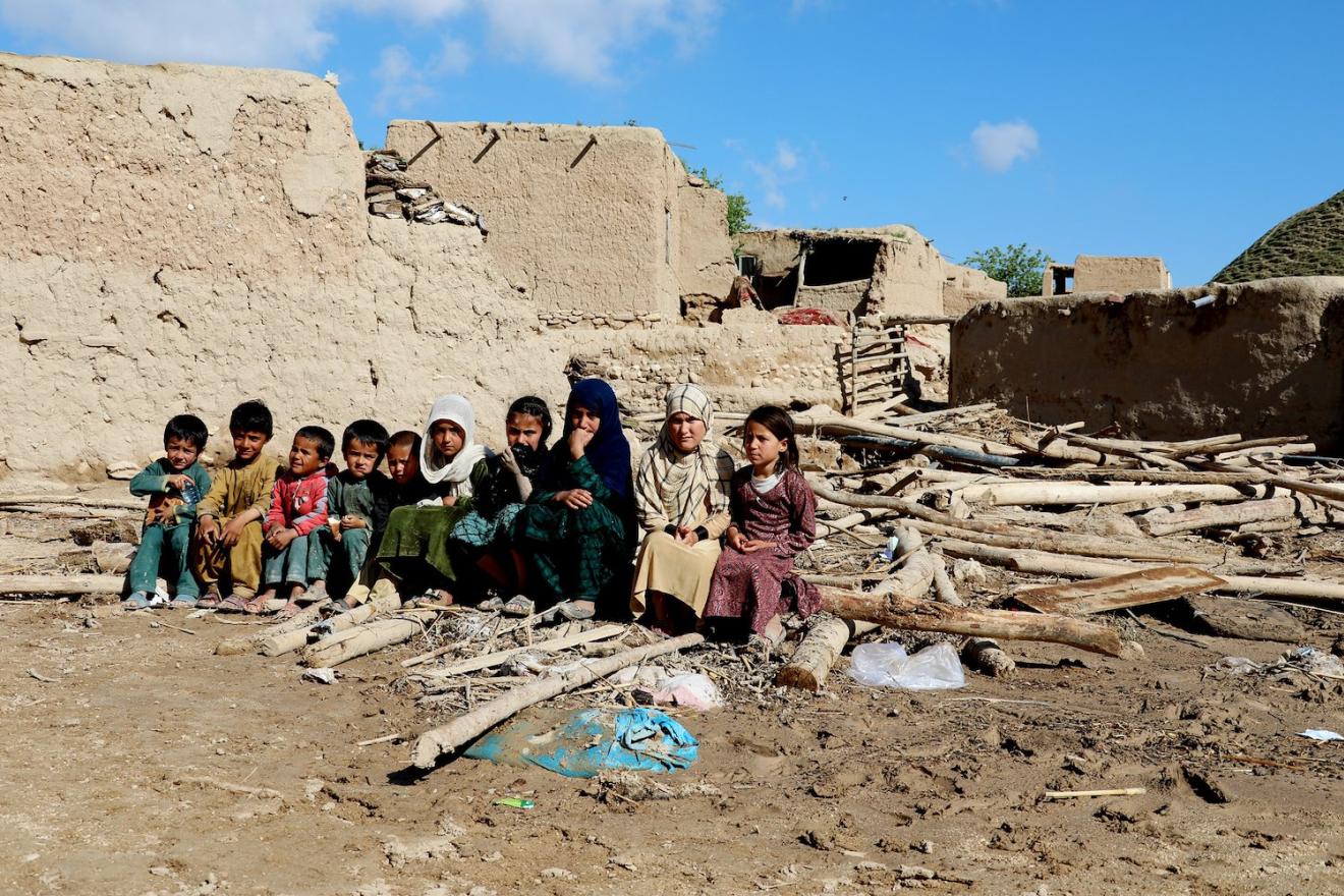 children sitting on bare ground