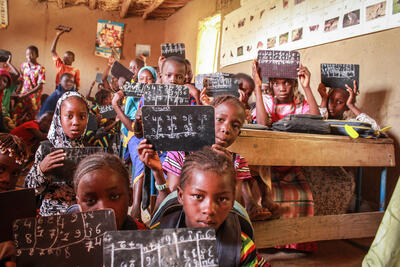 Children working with chalk and slates in classroom