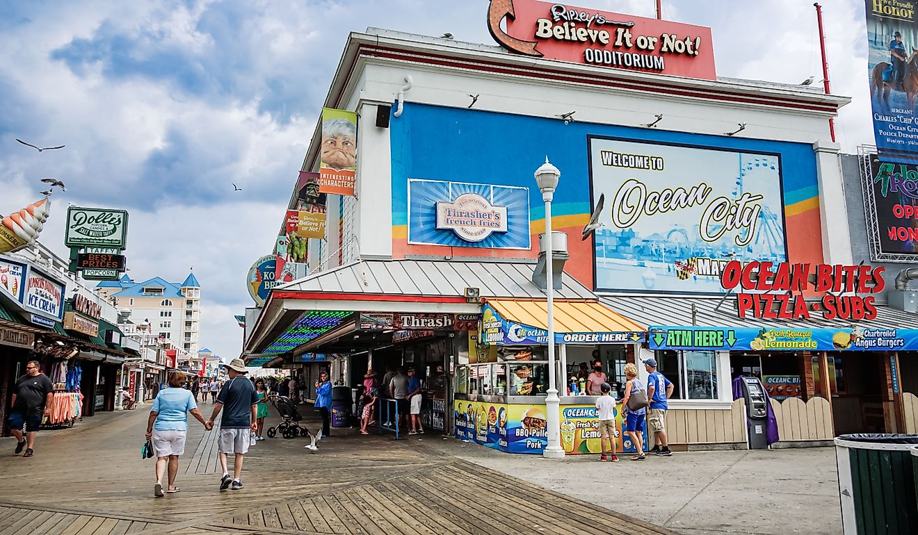 Tourists walk along the shops, attractions and food establishments on the boardwalk at Ocean City, Maryland. Editorial credit: eurobanks / Shutterstock.com