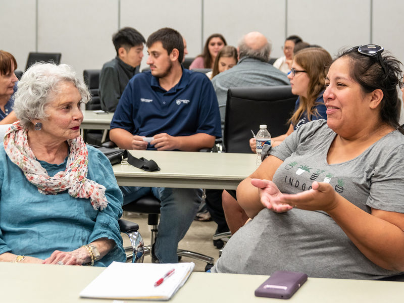 A multi-generational conversation between two people at an OLLI event