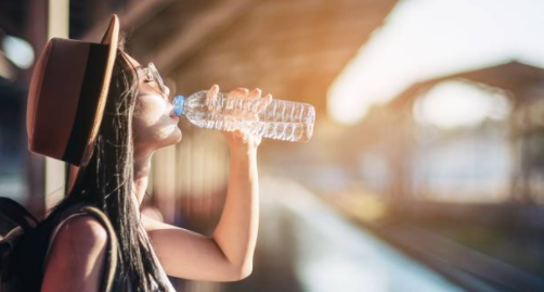 woman drinking water from a bottle