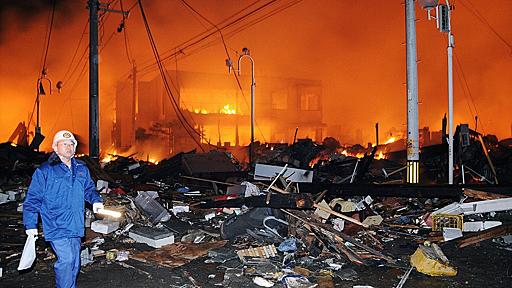 Fires light up Japanese night after mega-quake and huge tsunami which wiped out towns, killed over 1,000 and cut power to millions