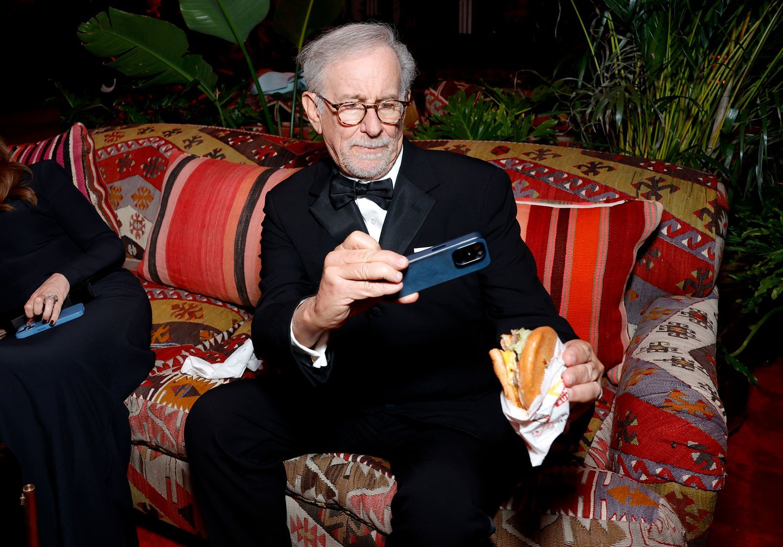 Image may contain Steven Spielberg Couch Furniture Accessories Formal Wear Tie Electronics Mobile Phone and Phone